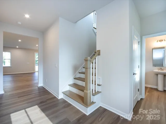 a view of a hallway with wooden floor and entryway