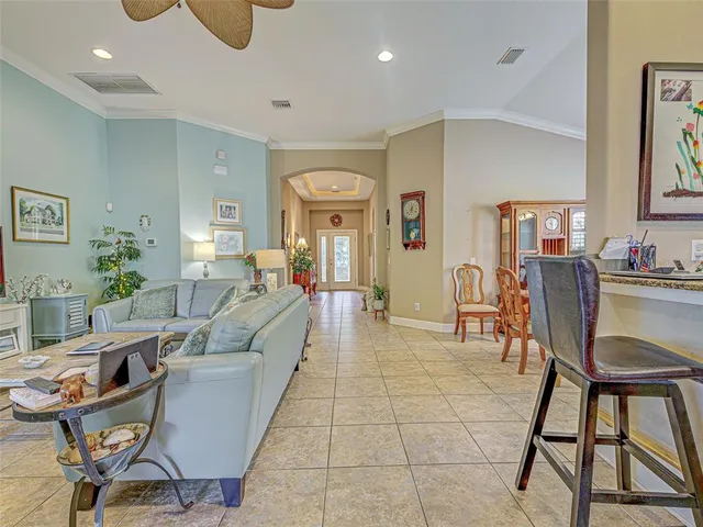 a dining room with furniture a chandelier and window
