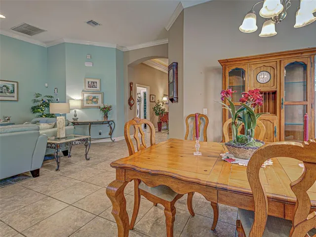 a view of a dining room with furniture and a window