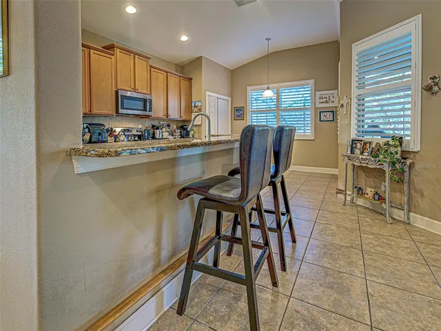 a kitchen with stainless steel appliances granite countertop a sink and cabinets
