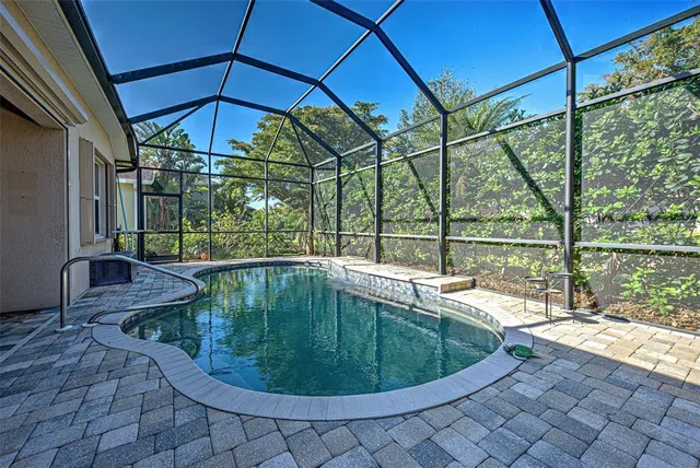 a swimming pool with outdoor seating and yard