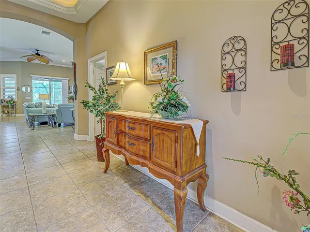 a living room with furniture a dining table and a potted plant