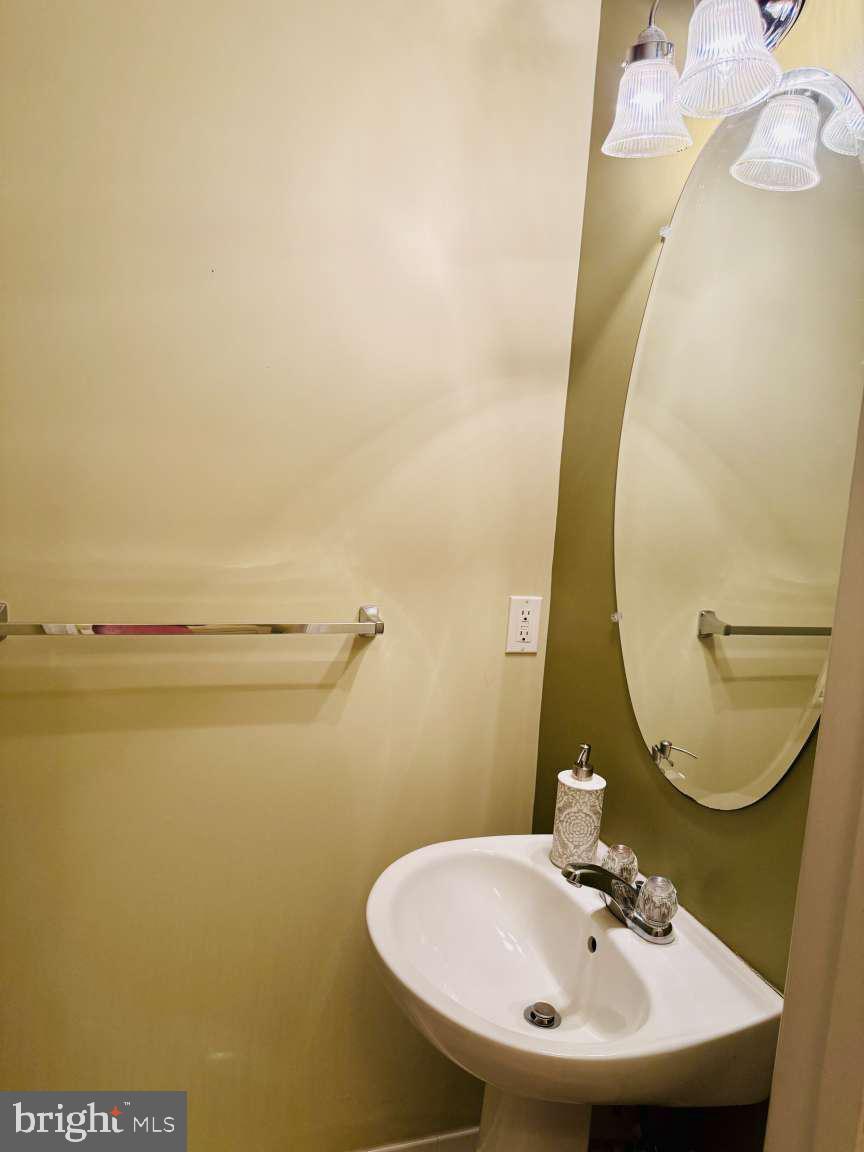 629 Ruxton Road, Unit 74 Solomons, MD 20629 - Photo 8 of 24 a bathroom with a sink and a mirror