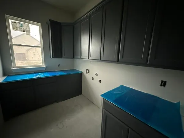 a kitchen with stainless steel appliances a sink a counter space and wooden floor