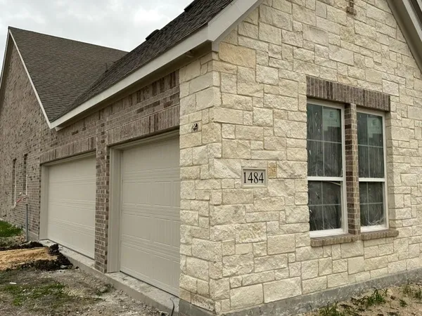 a brick house with a door and a window