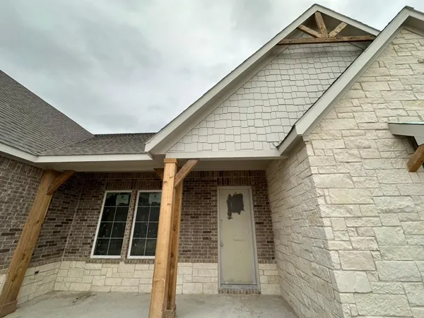 a front view of a house with large windows