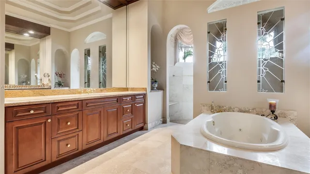 a bathroom with a granite countertop sink a toilet and shower