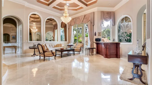 a living room with furniture fireplace and a large window