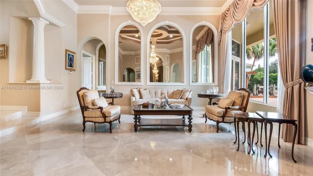 a living room with furniture a large window and a fireplace