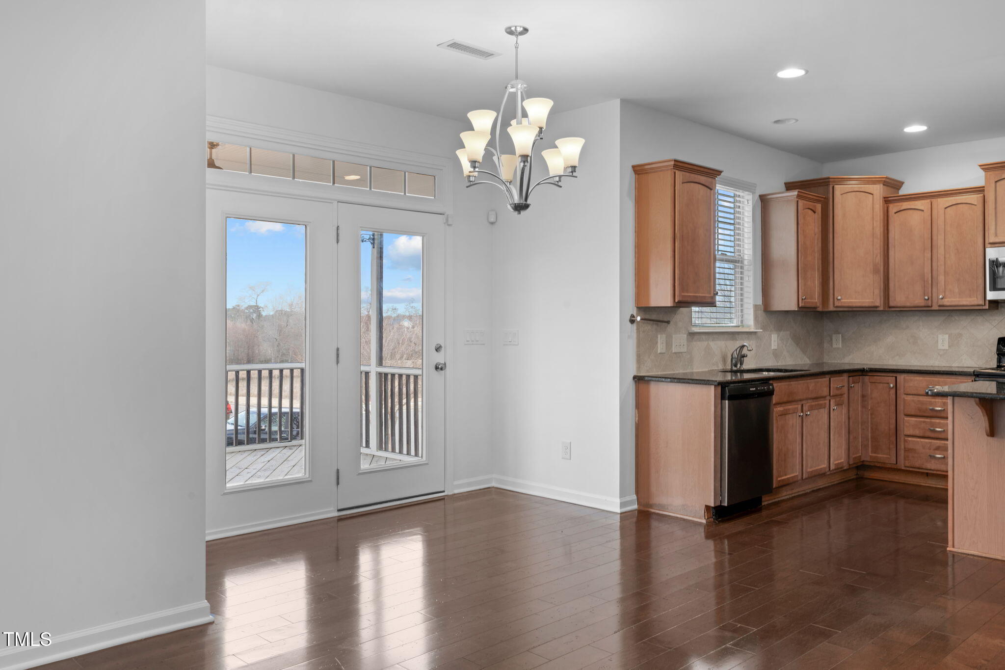 4139 Davis Meadow Street Raleigh, NC 27616 - Photo 13 of 43 a kitchen with stainless steel appliances granite countertop a refrigerator a sink dishwasher a oven and white cabinets with wooden floor