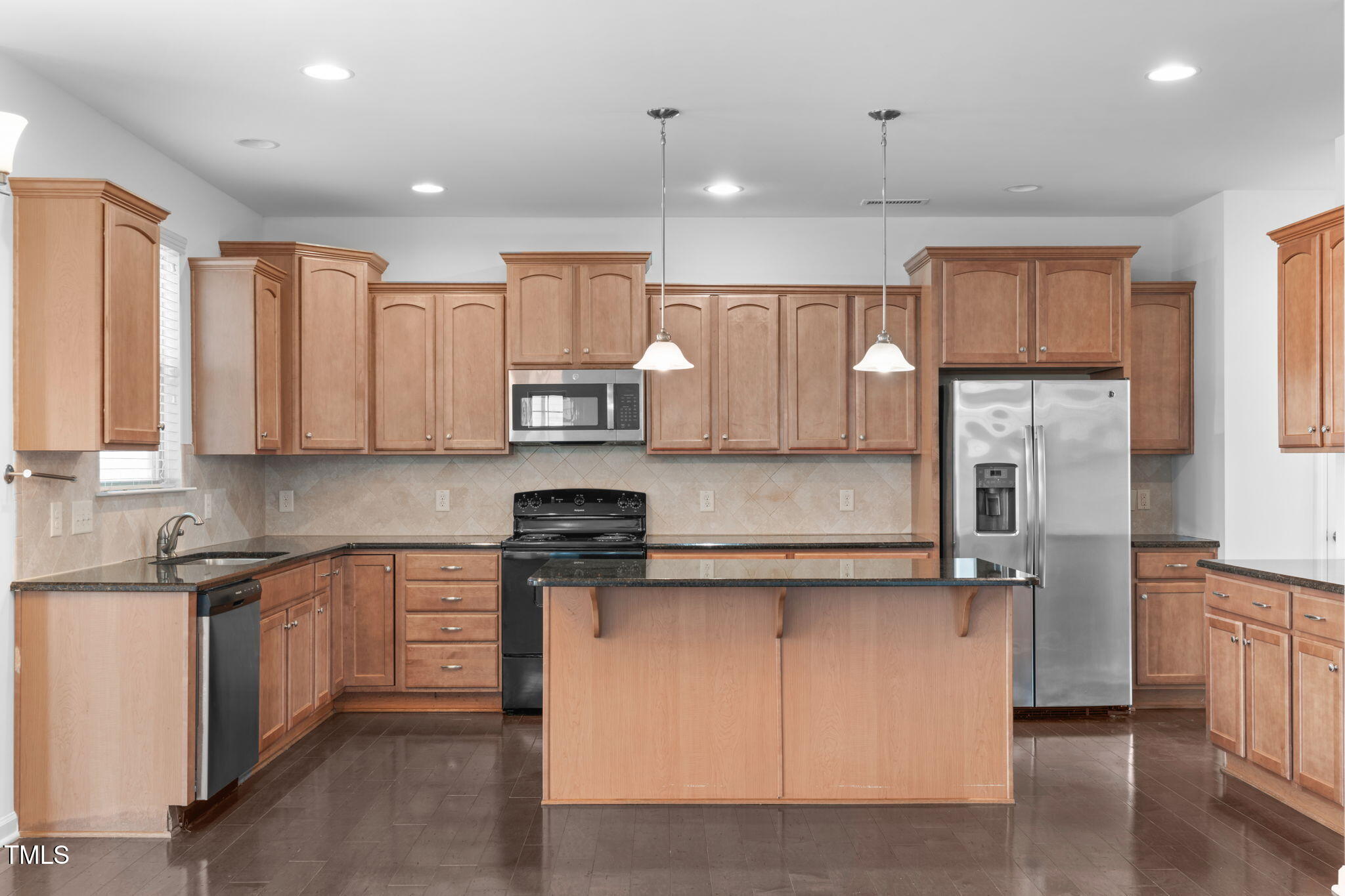 4139 Davis Meadow Street Raleigh, NC 27616 - Photo 14 of 43 a kitchen with stainless steel appliances granite countertop a stove a sink and white cabinets