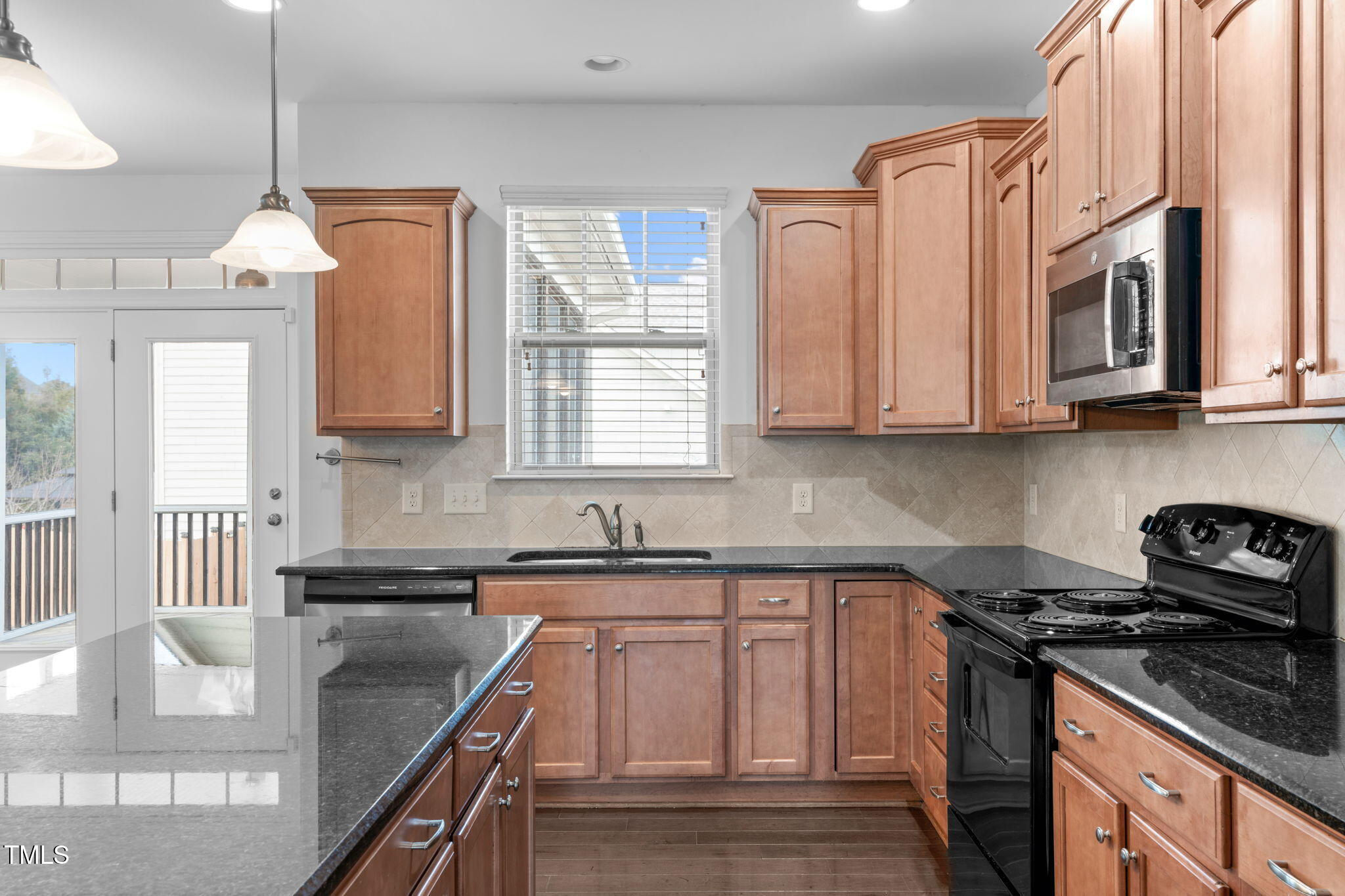 4139 Davis Meadow Street Raleigh, NC 27616 - Photo 17 of 43 a kitchen with stainless steel appliances granite countertop a sink stove and cabinets
