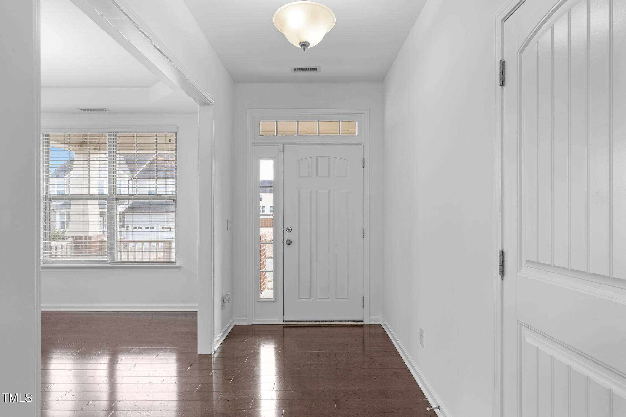 4139 Davis Meadow Street Raleigh, NC 27616 - Photo 4 of 43 a view of an empty room with wooden floor and a window