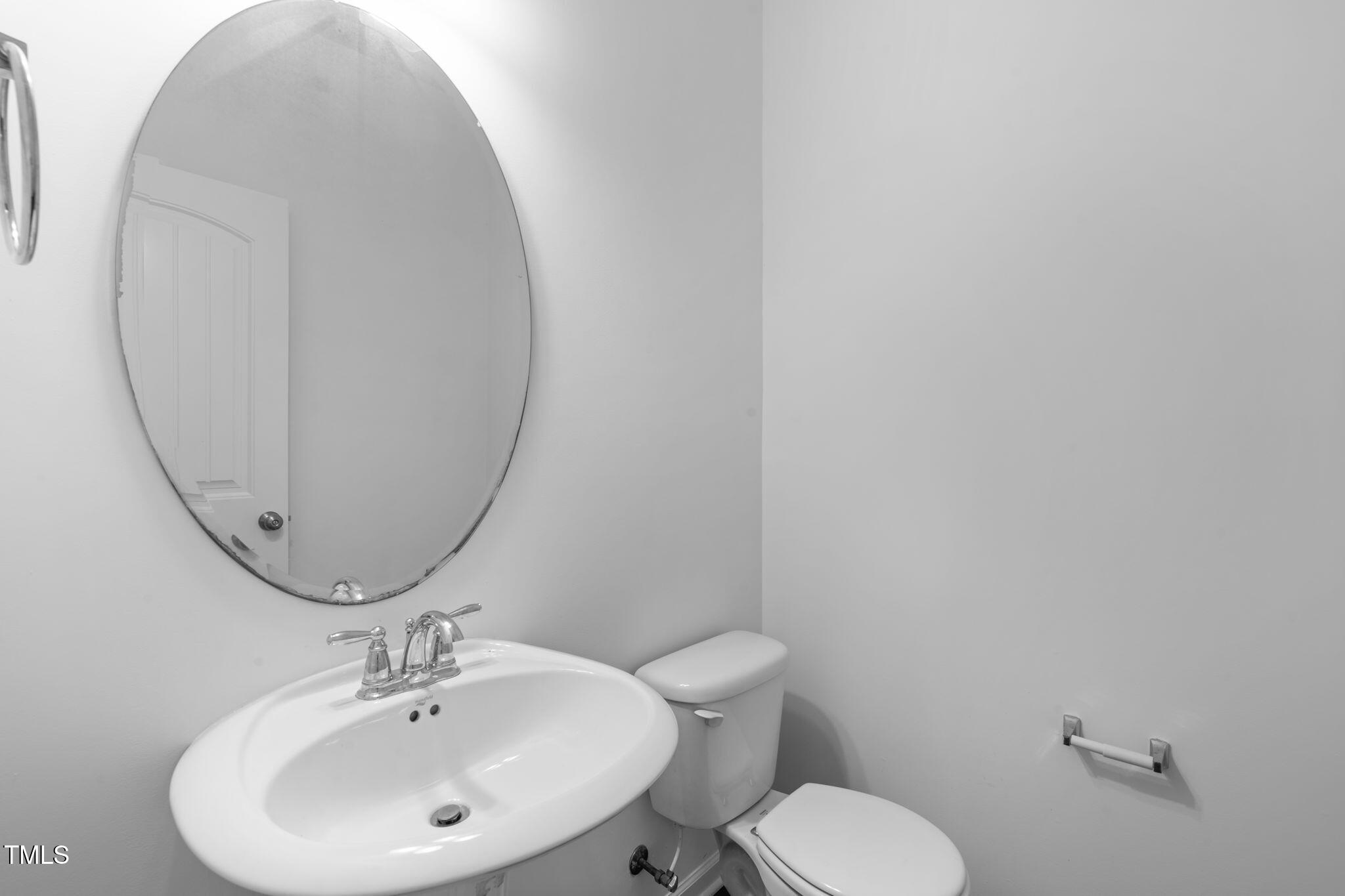 4139 Davis Meadow Street Raleigh, NC 27616 - Photo 8 of 43 a bathroom with a sink mirror and toilet