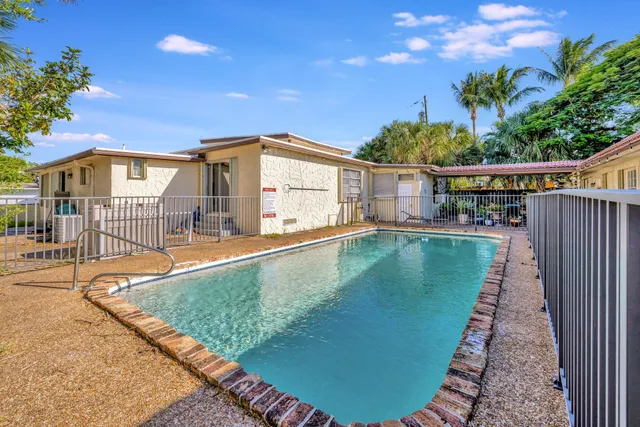 swimming pool view with a garden space