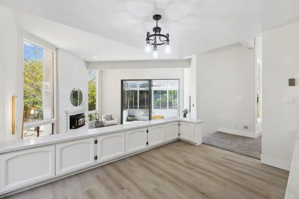 a large white room with a large window and sink