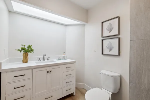 a bathroom with a toilet sink and mirror