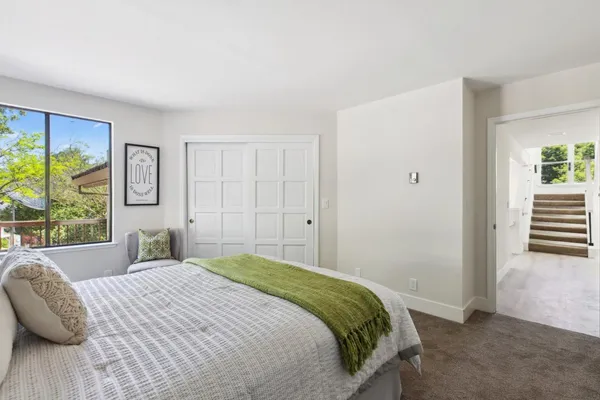 a bedroom with a large bed and a window