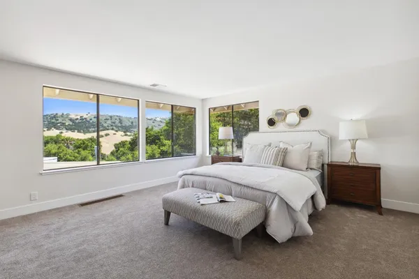 a bedroom with a bed and a large window