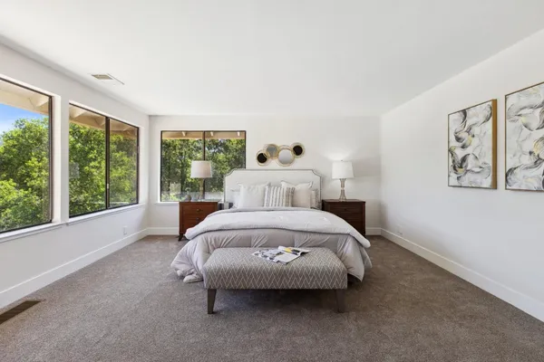 a spacious bathroom with a double vanity sink and mirror