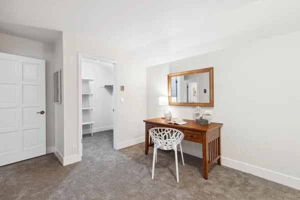 a bedroom with a bed and a chair