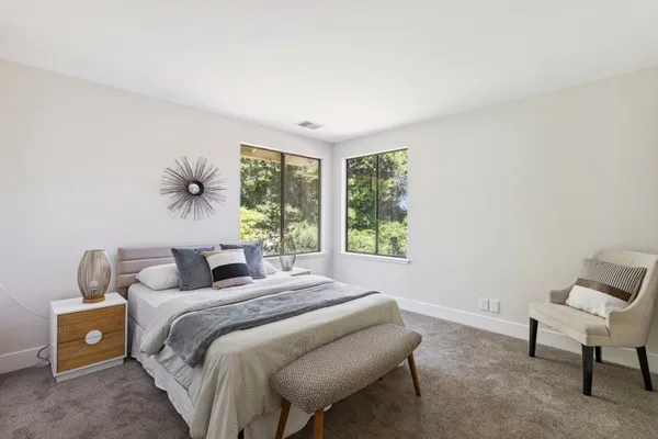 a bedroom with a bed and a chair