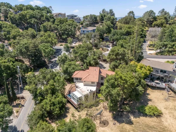 an aerial view of a house with yard swimming pool and outdoor seating