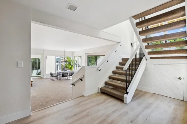 a view of entryway and hall with wooden floor