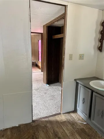 a view of hallway with stairs and a window