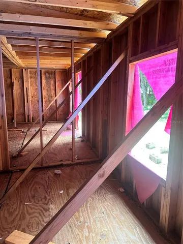 a view of a yard with wooden fence