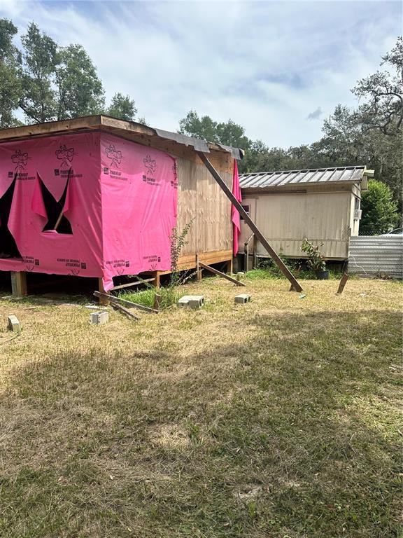 12232 Southwest 44th Drive Webster, FL 33597 - Photo 25 of 28 a backyard of a house with lots of green space and trampoline
