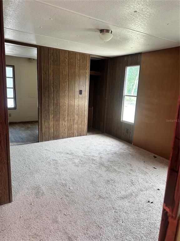 12232 Southwest 44th Drive Webster, FL 33597 - Photo 8 of 28 a view of hallway with windows and chandelier fan