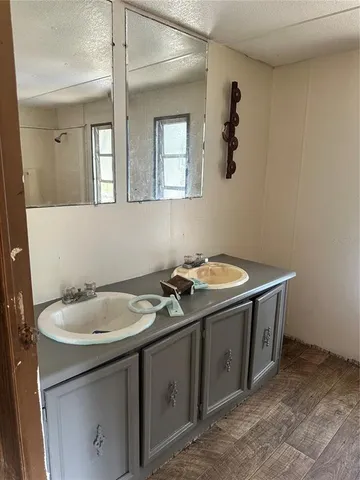 a bathroom with a tub a window and a shower