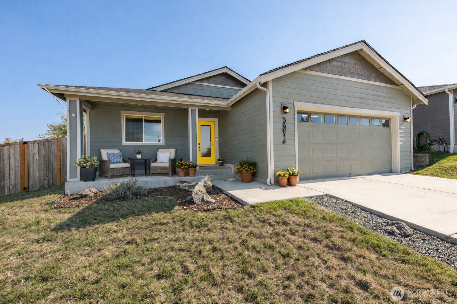 a view of a house with backyard and porch