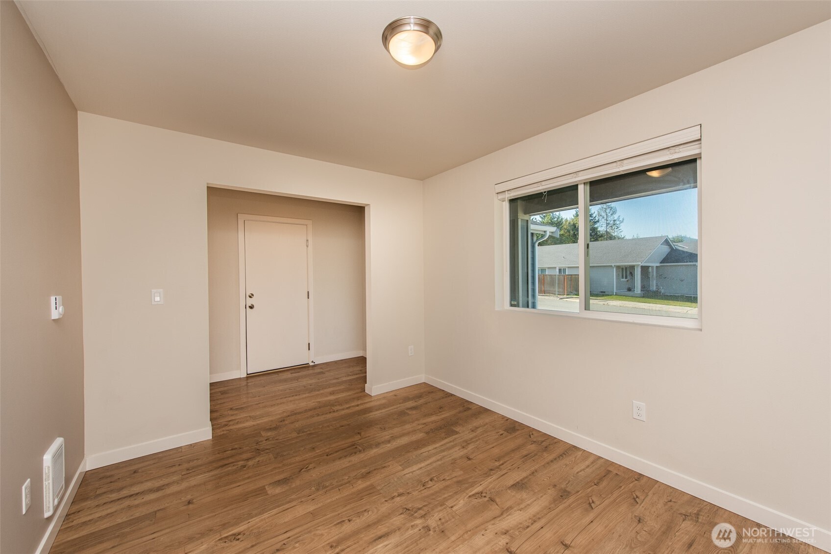 3601 Page Street Port Angeles, WA 98362 - Photo 19 of 40 a view of an empty room with wooden floor and a window