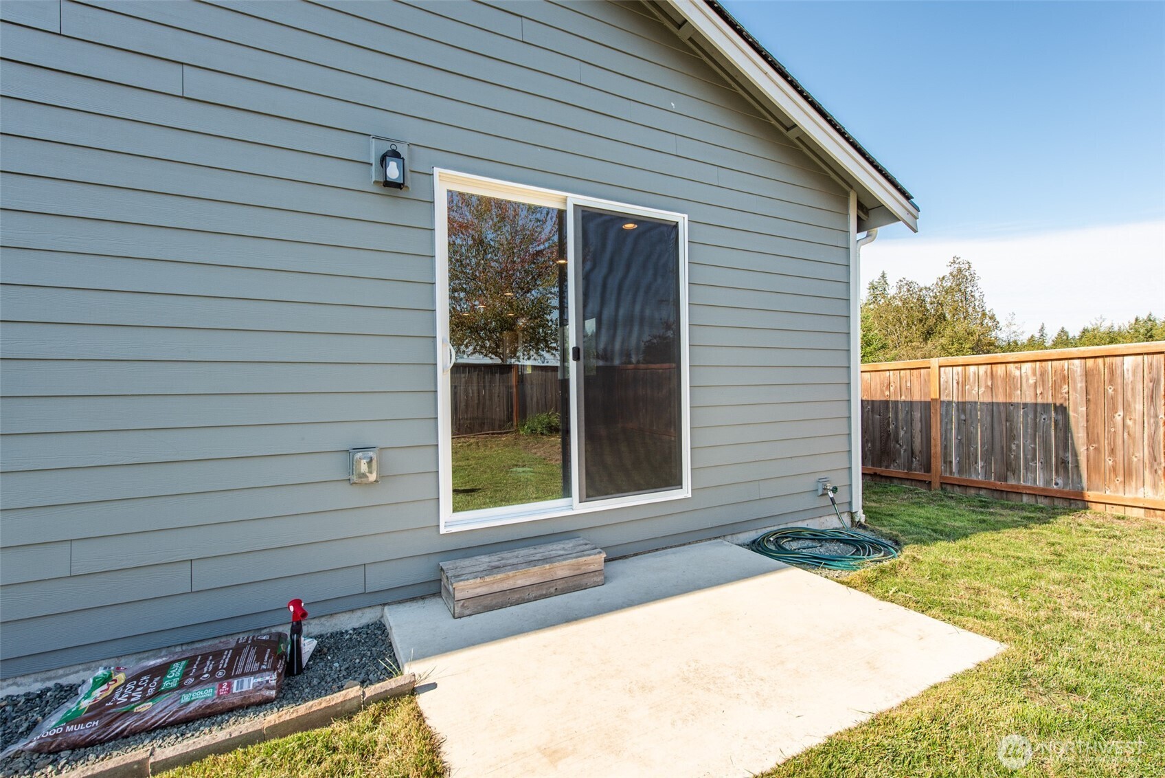 3601 Page Street Port Angeles, WA 98362 - Photo 32 of 35 a view of a backyard with chairs and floor to ceiling window