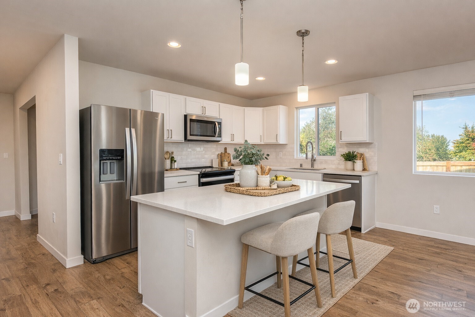 3601 Page Street Port Angeles, WA 98362 - Photo 10 of 40 a kitchen with stainless steel appliances granite countertop a sink a stove a refrigerator cabinets a dining table and chairs