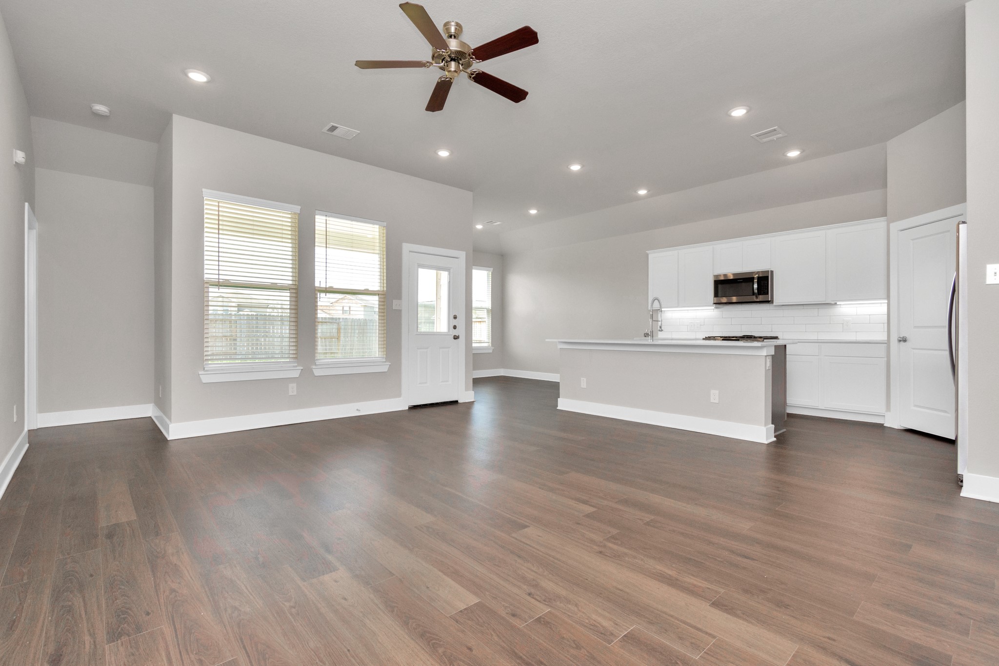 10502 Moon Valley Lane Rosharon, TX 77583 - Photo 6 of 23 a view of an empty room with window and wooden floor