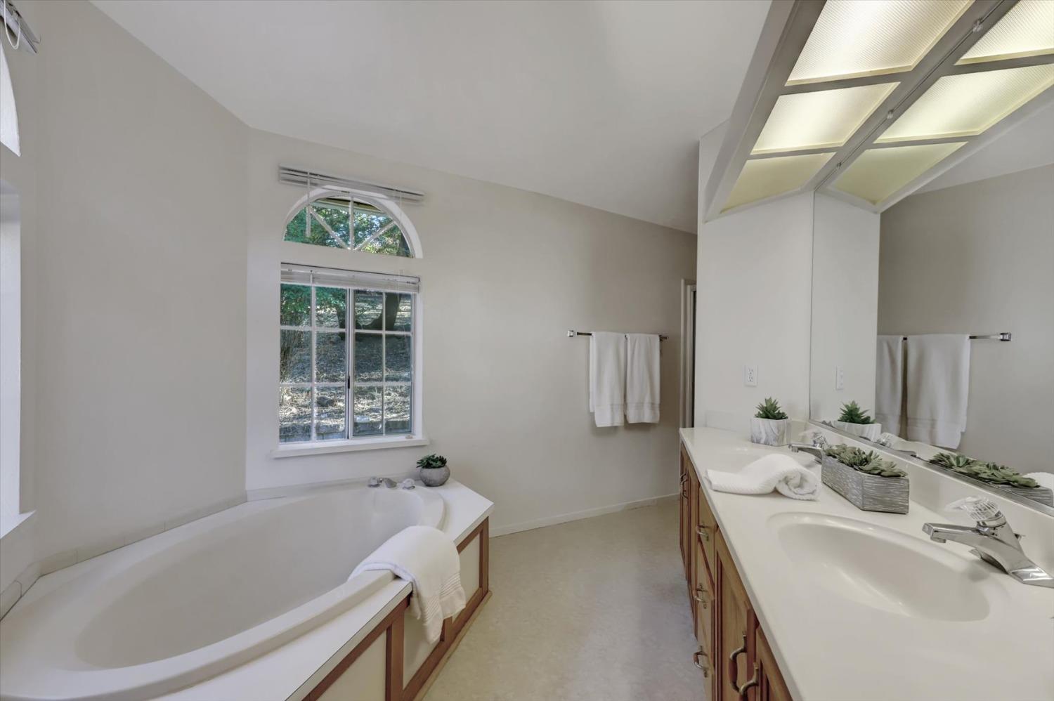 16260 Hillaire Road Rough and Ready, CA 95975 - Photo 12 of 45 a bathroom with a tub sink and mirror