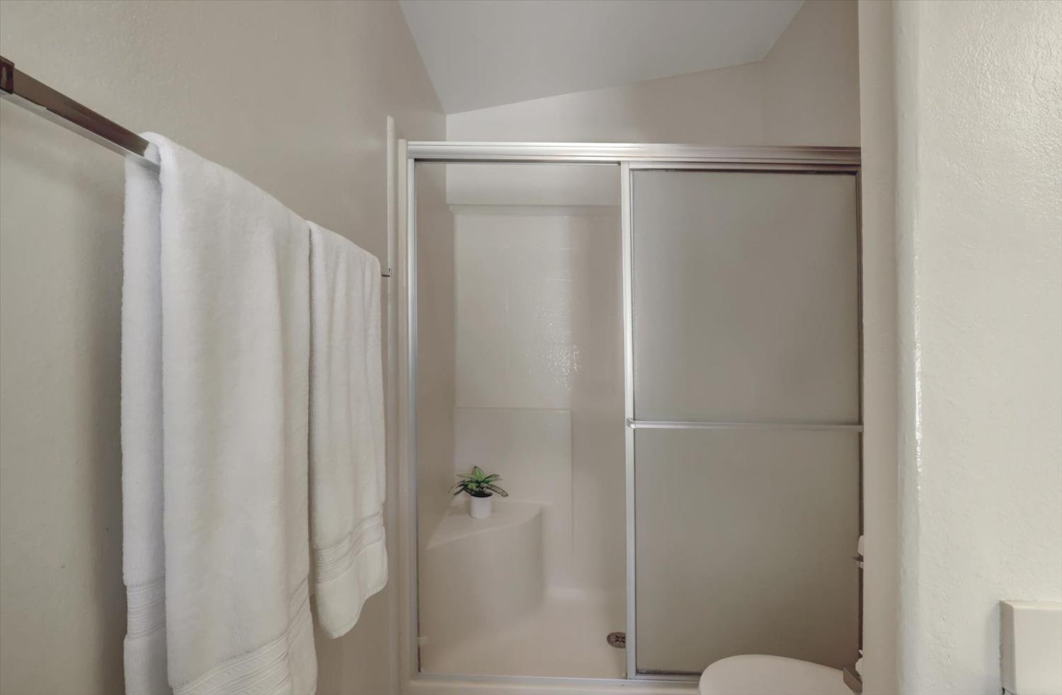 16260 Hillaire Road Rough and Ready, CA 95975 - Photo 13 of 45 a bathroom with a glass shower door