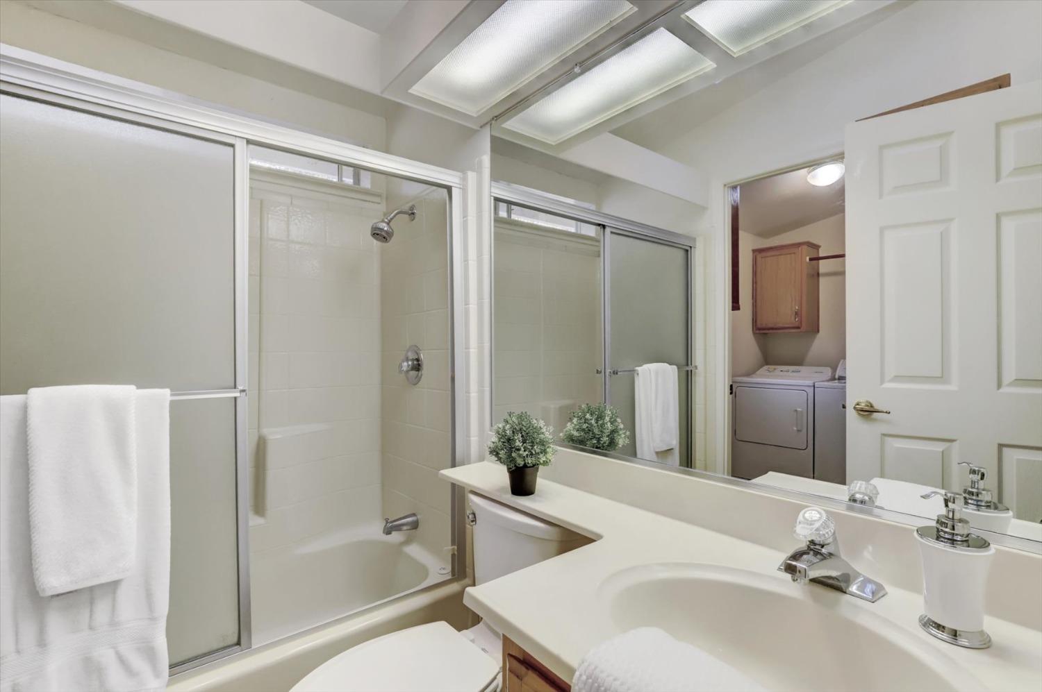 16260 Hillaire Road Rough and Ready, CA 95975 - Photo 15 of 45 a bathroom with a bathtub shower sink vanity and a mirror