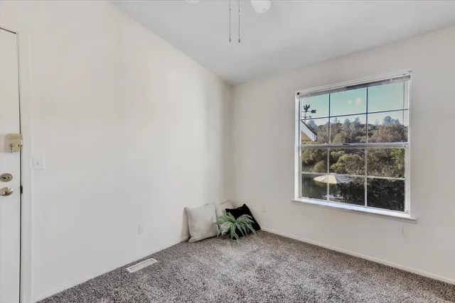 an empty room with windows and closet