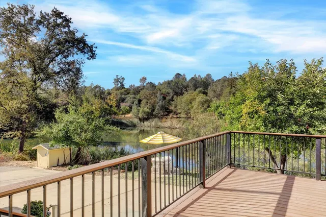 a view of a balcony with wooden floor and outdoor seating