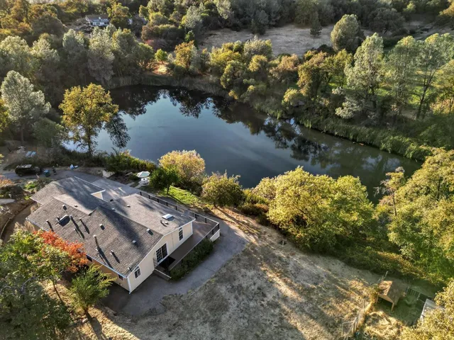 an aerial view of a house with a lake view