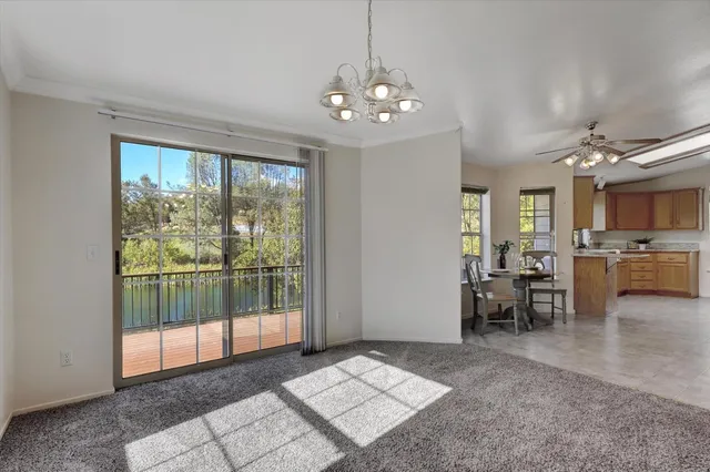 en view interior of a house with hallway chandelier and livingroom