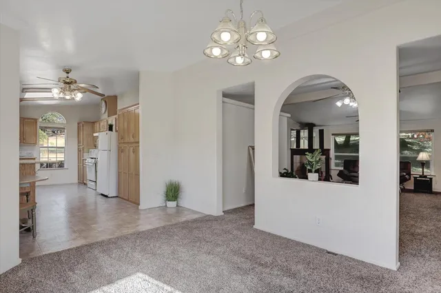 a kitchen with stainless steel appliances granite countertop a refrigerator a stove and a sink with granite countertops