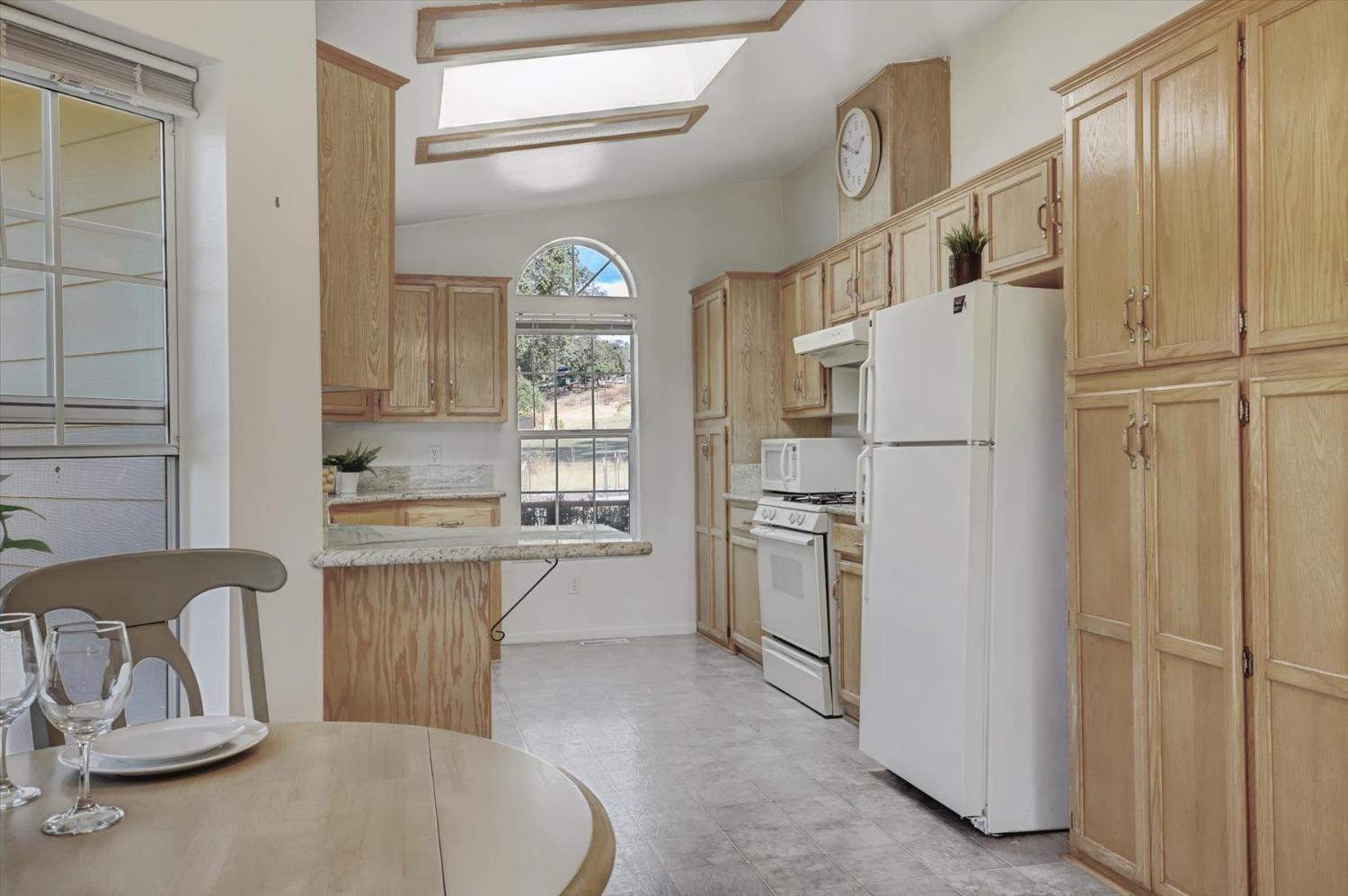 16260 Hillaire Road Rough and Ready, CA 95975 - Photo 7 of 45 a kitchen with stainless steel appliances granite countertop a refrigerator a stove and a sink with granite countertops