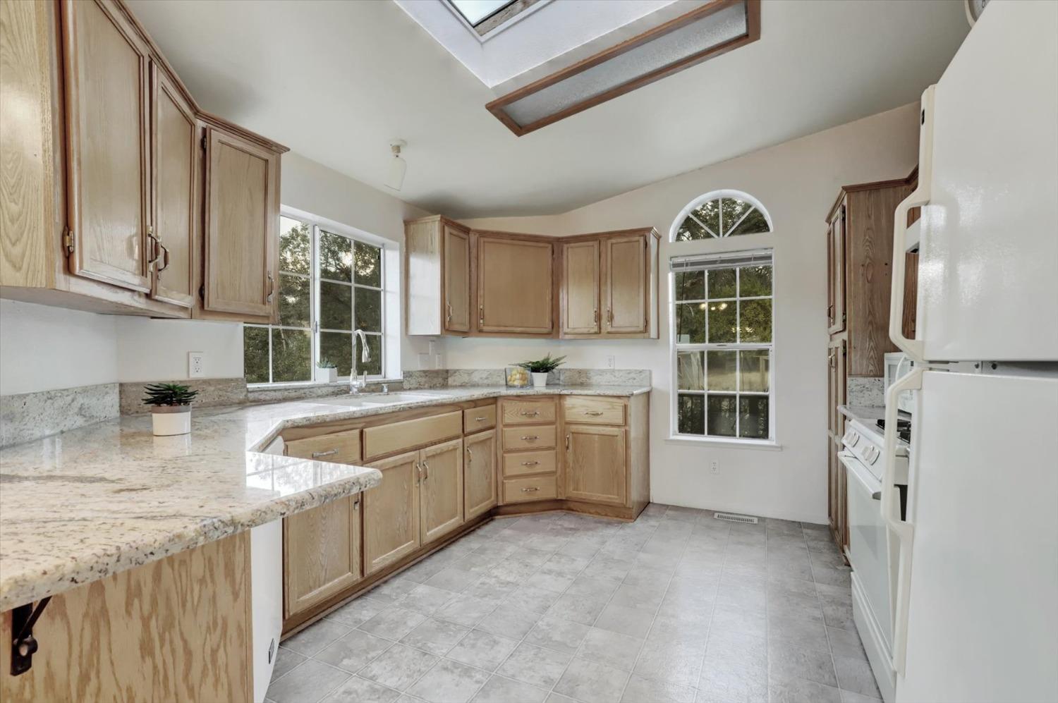 16260 Hillaire Road Rough and Ready, CA 95975 - Photo 8 of 45 a kitchen with stainless steel appliances granite countertop a sink stove and cabinets