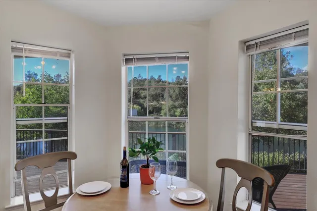 a bedroom with a large bed and a chandelier fan