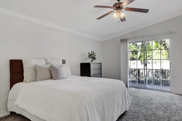 a bedroom with a large bed and a window